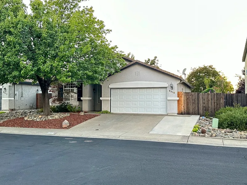 Suburban home with a white two-car garage door in Santee